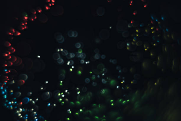 istock Beautiful multi colored light bokeh on a black background. 1169434528