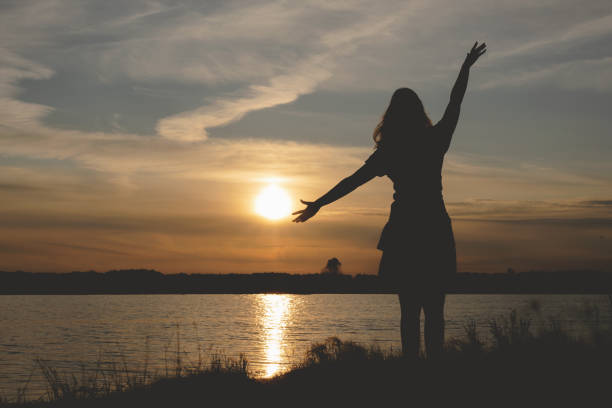istock Silhouette of young dancing woman. 1169435596