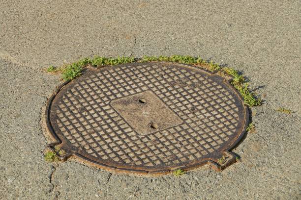 istock old brown sewer manhole on gray asphalt road 1169435650