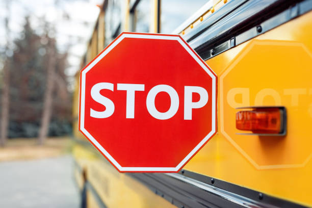 Close up on school bus with stop sign