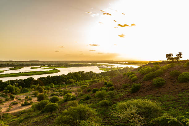 Sunset over meanders, islands and green shores of Niger river seen from higher ground during outside Niamey capital of Niger during humid season in summer Kanazi area sahel stock pictures, royalty-free photos & images