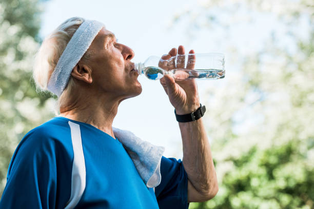istock low angle view of senior man drinking water from bottle 1169439292