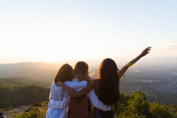 istock Women on mountain peak cliff 1169439345
