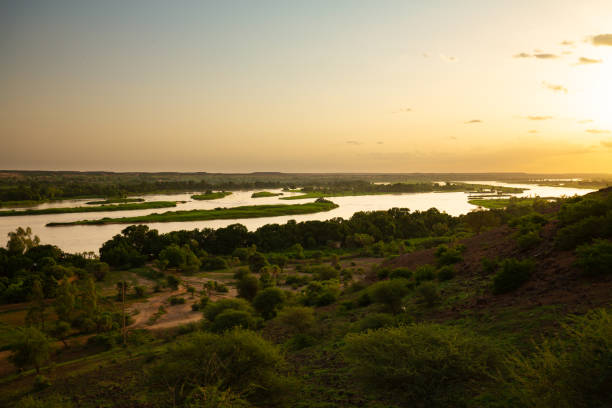 Sunset over meanders, islands and green shores of Niger river seen from higher ground during outside Niamey capital of Niger during humid season in summer stock photo