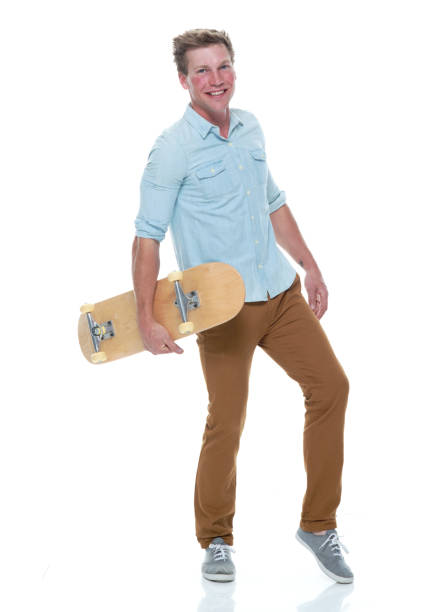 istock Casual well dressed man holding a skateboard 1169440738
