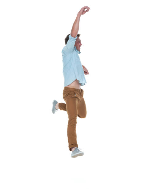 istock Casual well dressed man jumping 1169440805
