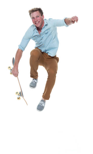 istock Casual well dressed man jumping with a skateboard 1169440810