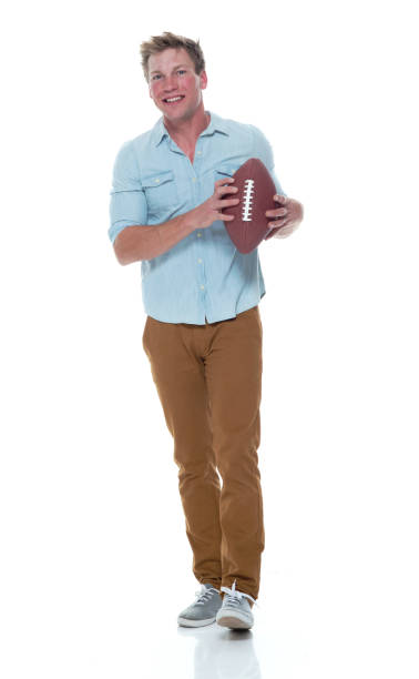 istock Casually dressed man holding a football 1169440907