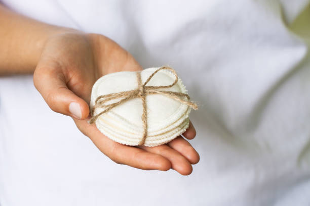 Reusable cotton pads in the woman's hand