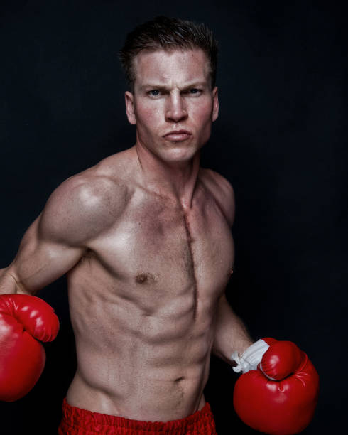 istock Sexy male boxer on black background 1169443748