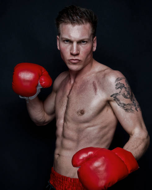 istock Sexy male boxer on black background 1169443755
