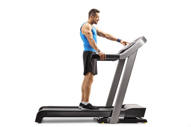 istock Muscular man turning on treadmill 1169444895