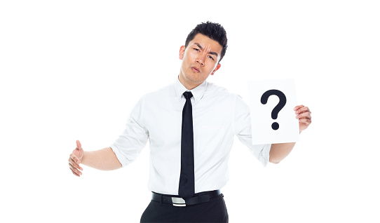 Handsome Asian Businessman - is holding a question mark sign