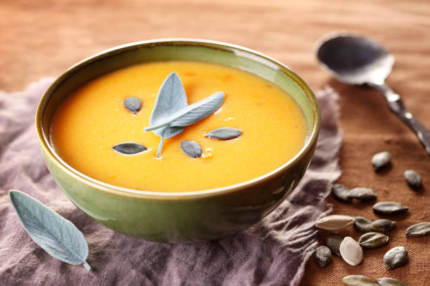 Creamy Pumpkin Soup Vegan pumpkin cream soup with sage. squash soup stock pictures, royalty-free photos & images