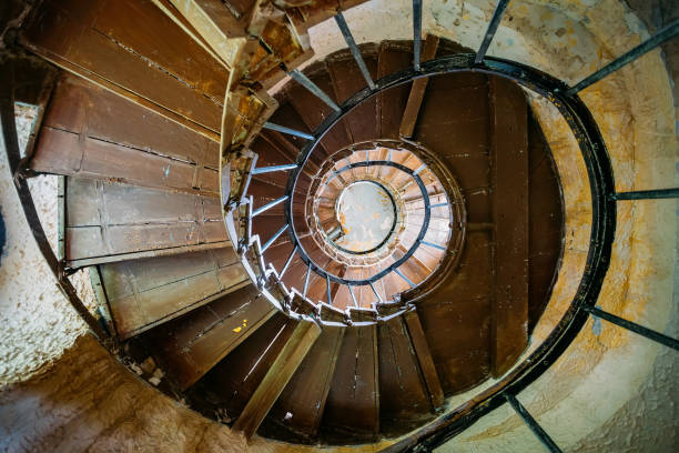 Old spiral staircase in abandoned mansion, bottom view.