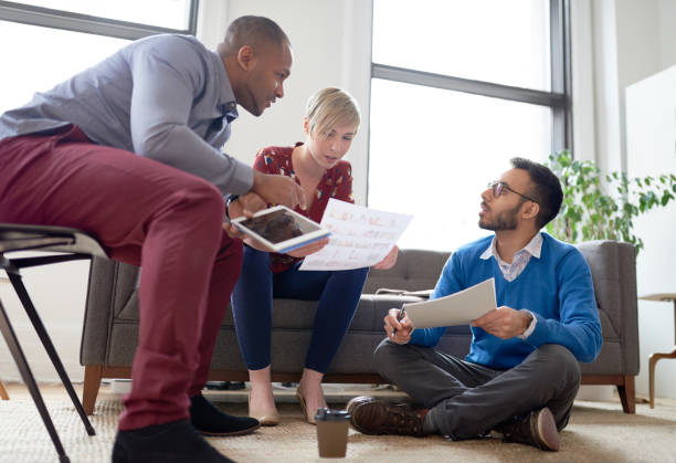 istock Multi-ethnic team of creative millenials collaborating on a brainstorm project 1169460165