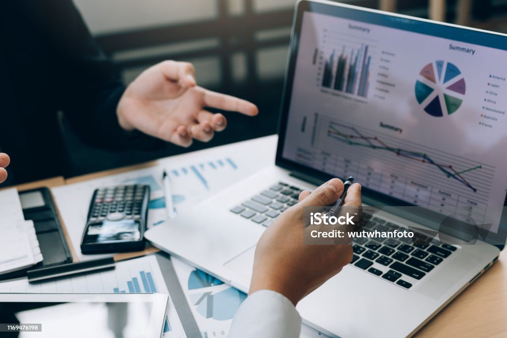 Colleagues are stress talking about the results report and compared with the financial information on the laptop screen. Finance Stock Photo