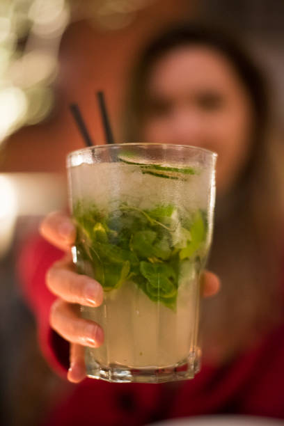 istock Woman offering a mojito cocktail 1169480534