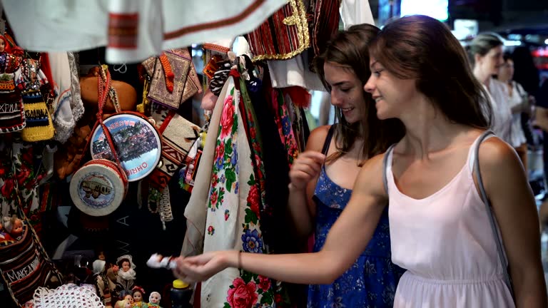 Buying local destination traditional clothes and souvenirs on summer vacation