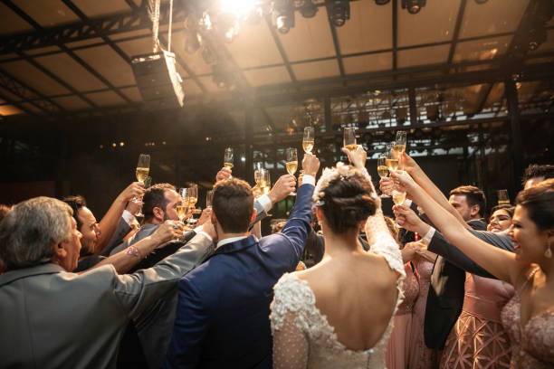 istock Bride, groom and wedding guests making a toast 1169482029