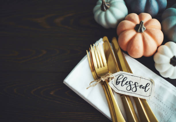 istock Thanksgiving Table Setting Background with Pumpkins and Gold Cutlery 1169482285