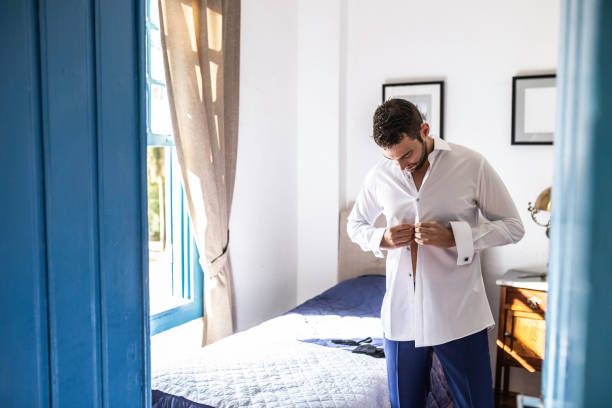 Groom getting dressed for the wedding celebration
