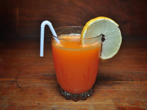 istock Orange juice on wooden table 1169488896