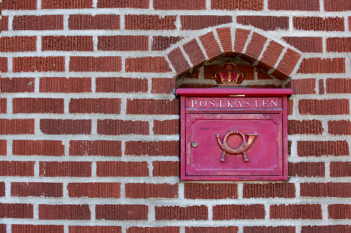 Green mailbox hanging on the wall