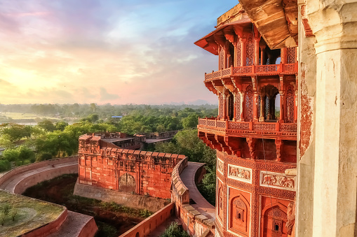 Agra Fort - Famous medieval historic fort exterior structure with view of Agra city landscape at sunrise