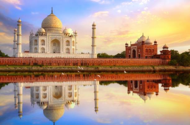istock Taj Mahal Agra at sunset with water reflection and moody sky 1169495933