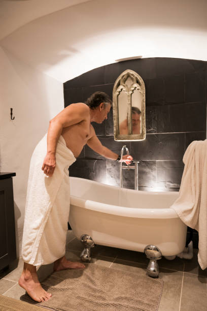 Man filling a clawfoot tub
