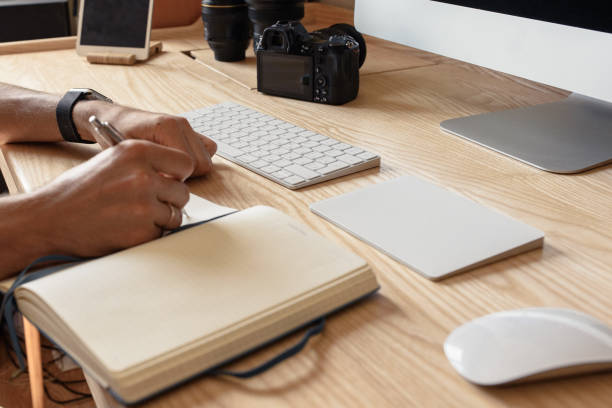 istock the photographer sits at a table and writes in a notebook 1169499031