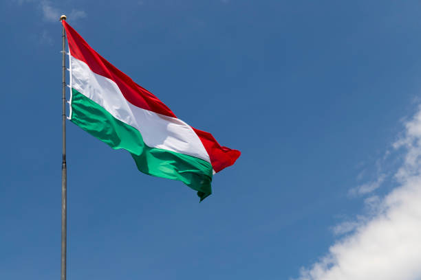 istock Hungarian flag on blue sky 1169500665