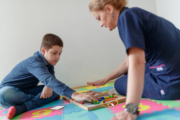 istock Practicing opposition of thumb with a tutor 1169502163