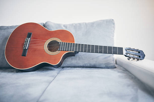 istock Acoustic guitar on a living room couch / sofa. 1169502998