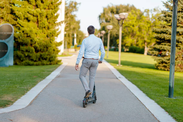 istock Commuter moving away on his e-scooter down the alley 1169503201
