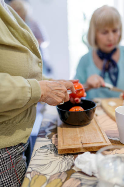 istock Holding tomatoes and cutting into a bowl 1169507357