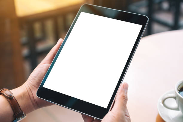 istock hands holding black tablet pc with blank white desktop screen 1169507617
