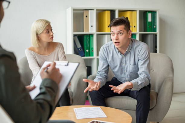 istock Man discusses something with therapist 1169509007