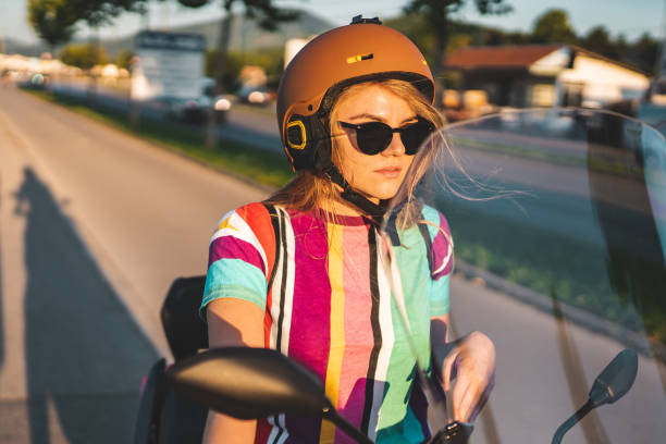istock Beautiful young girl on scooter 1169509322