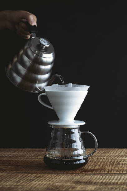 istock black coffee drip On the wood Dark tone 1169515331