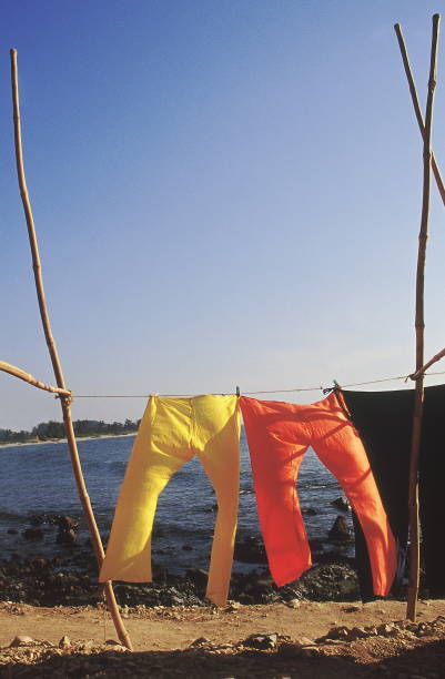Bright trousers hanging out to dry on the seashore.