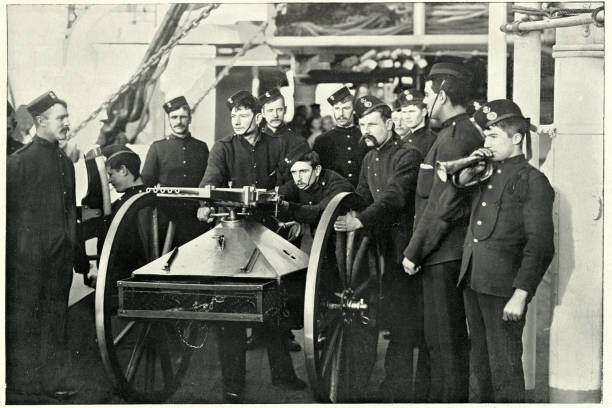 istock Warship crew practicing to repel boarders with machine gun, 1890s 1169516403