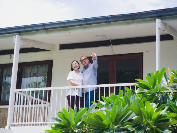istock elder couple standing on the balcony 1169517942