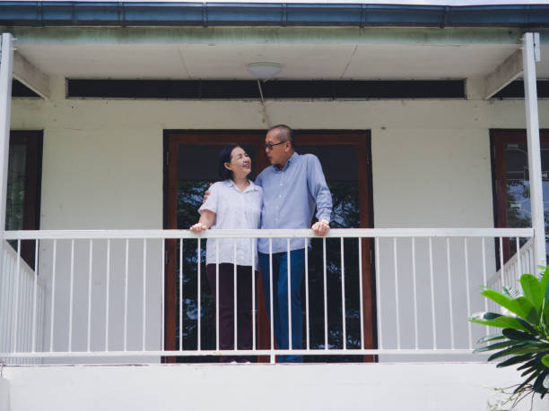 istock elder couple standing on the balcony 1169517962