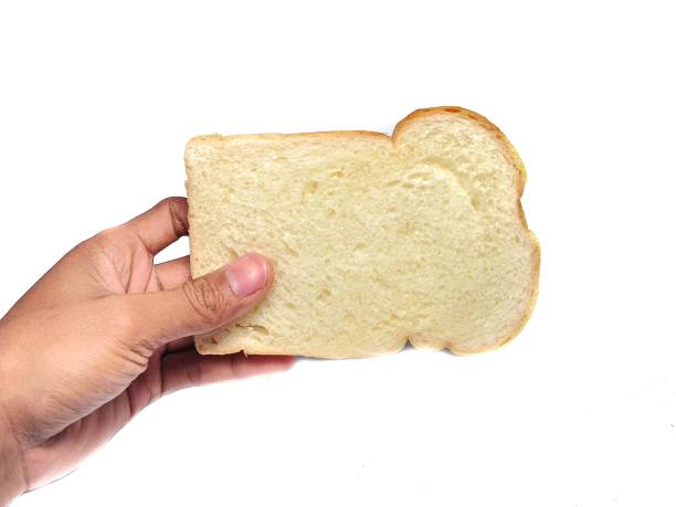 istock Hand holding slices of white bread isolated on white background 1169519474