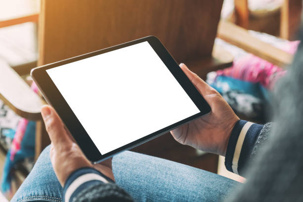 istock a woman holding black tablet with blank white desktop screen 1169522291