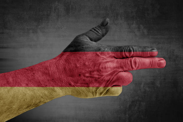 Germany flag painted on male hand like a gun