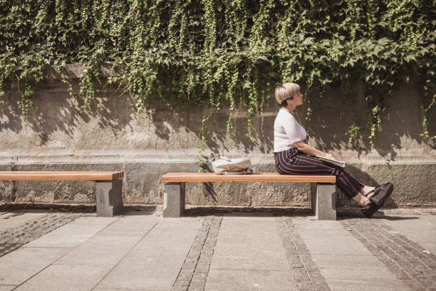istock Female university student resting on the park bench 1169524292
