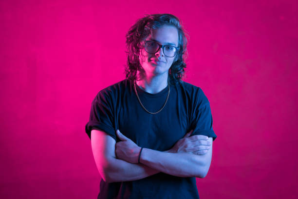 istock Portrait of smiling young man on neon colored 1169524889